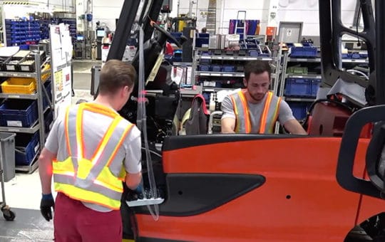 two assemblers with flashing safety distance vest