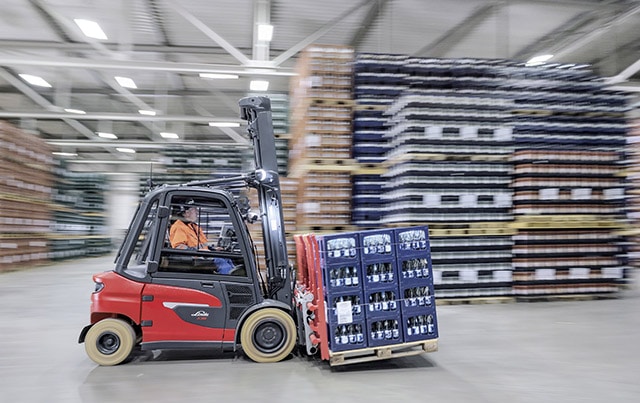 new linde e stacker transports goods through the warehouse