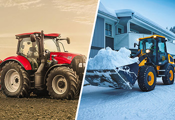 Traktor auf Feld und Radlader im Schnee