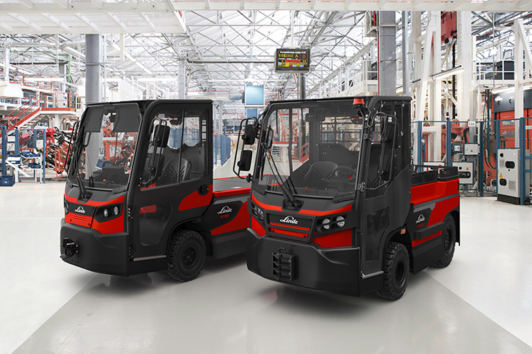 presentation linde electric tractor p120 p350 and lorry w20 w30 two red linde vehicles in hall