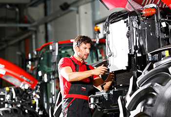 Agricultural technology service technician during repair