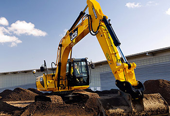 Yellow JCB excavator digging