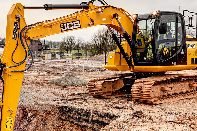 JCB earth moving machine yellow digging hole