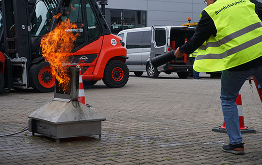 Man extinguishes fire at fire safety helper training course