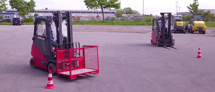 Two red Linde forklifts on training ground of GRUMA Academy