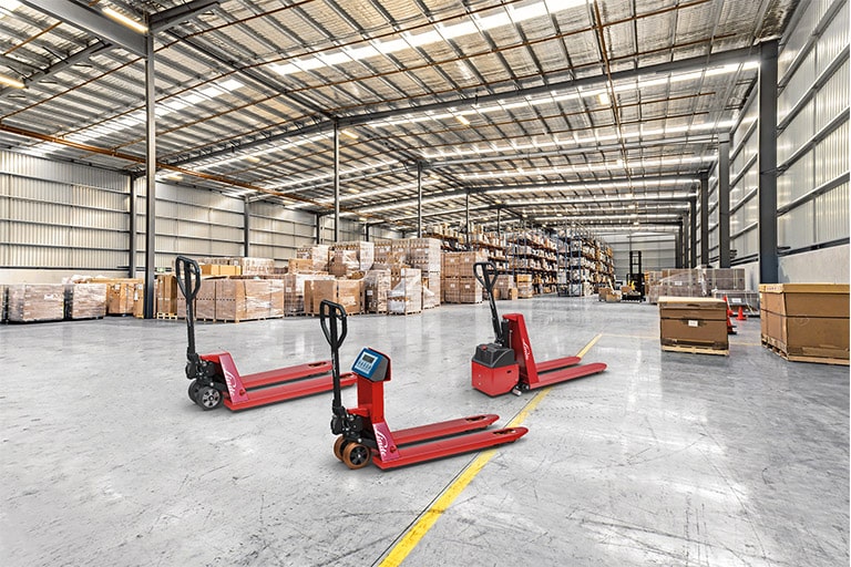 Three lift trucks red Linde warehouse with scales