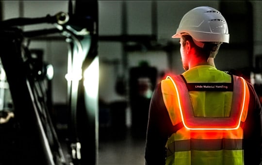 Man with Safety Guard high visibility vest from behind