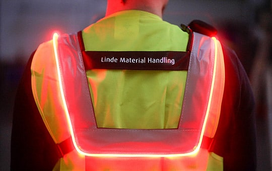 Close up man with Safety Guard high visibility vest from behind