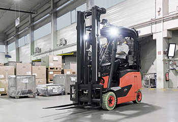 Forklift truck with light spotlight in warehouse and man