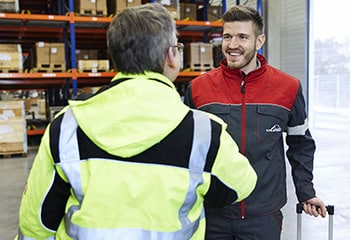 Preview service technician greets customers for forklift service